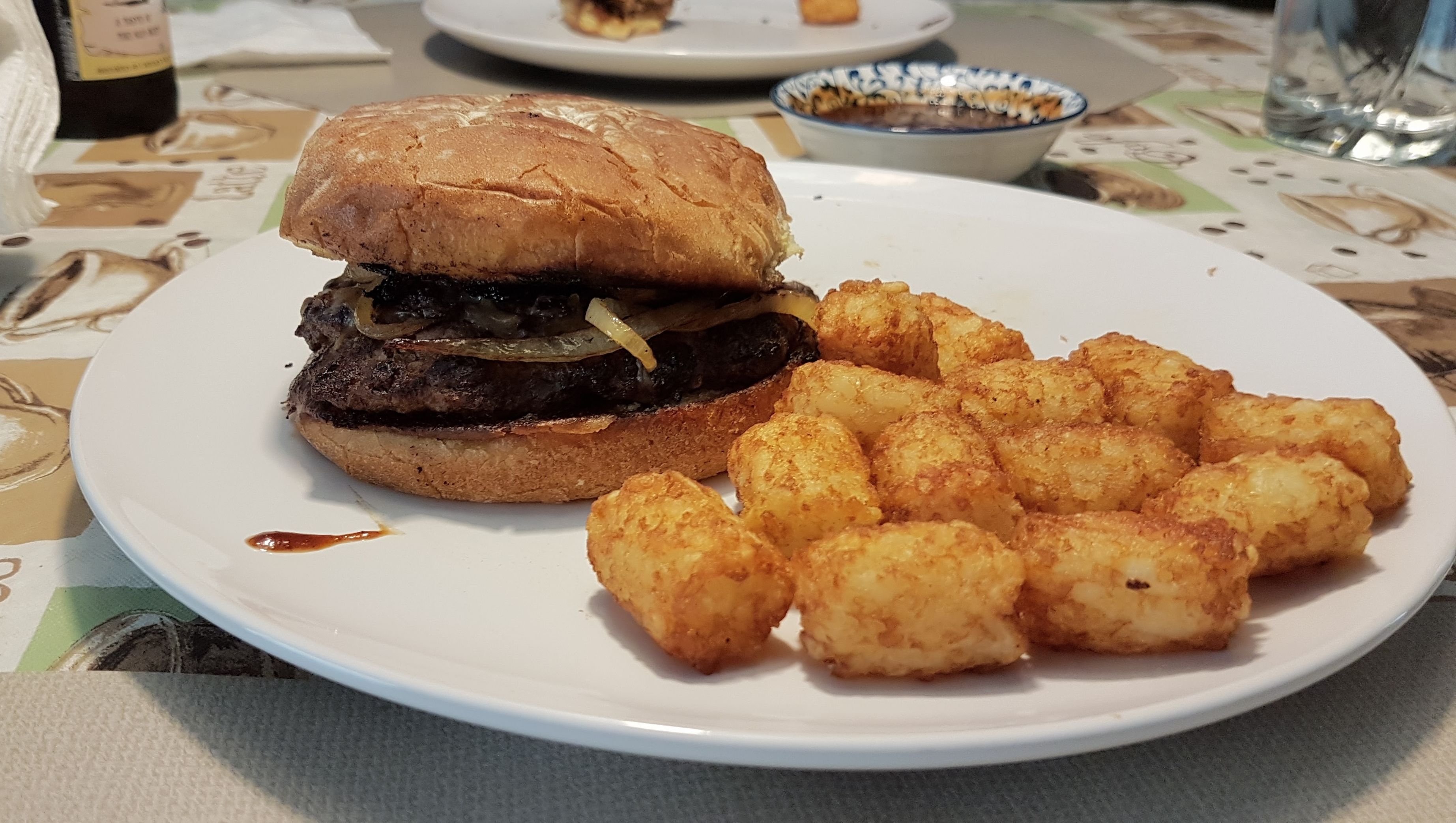 Barbecue burger with tater tots.
